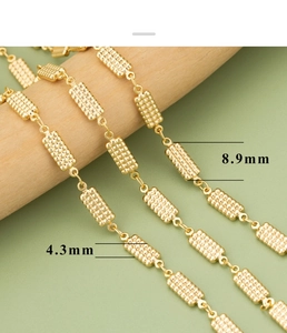 Macro detail of 18k gold plated geometric chain link with textured surface and 8.9mm size