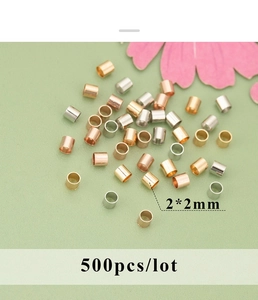 Macro shot of 2x2mm 18K gold plated cylinder crimp beads for DIY jewelry making