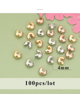 Macro detail of 4mm 18K gold plated C-type crimp bead covers for jewelry making