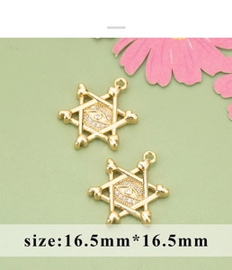 Detail view of gold hexagram evil eye charms with pavé zircon and 16.5mm size measurement