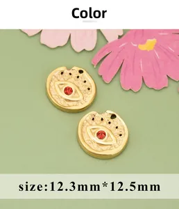 Macro view of gold flower evil eye pendants with red rhinestones and 12.3mm dimensions