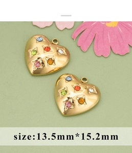 Detailed view of heart-shaped gold pendants with colorful rhinestones measuring 13.5mm by 15.2mm