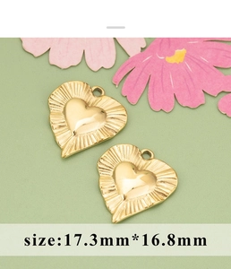 Macro shot of 17.3mm gold heart charms with radial textures for DIY jewelry making