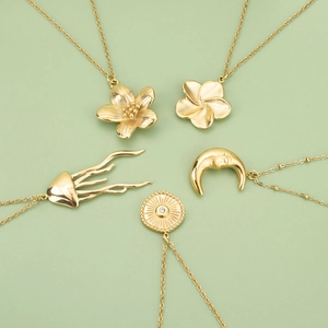 Gold titanium steel necklaces featuring floral, crescent moon and jellyfish pendants