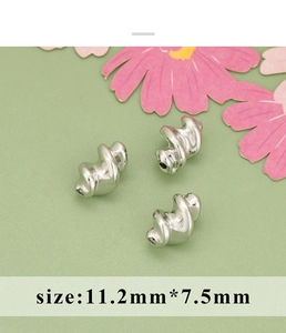 Close-up of three 11.2x7.5mm silver spiral texture metal beads for DIY jewelry making