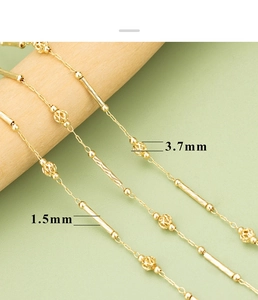Detailed macro view of 1.5mm cylinder bars and 3.7mm hollow beads on a gold chain