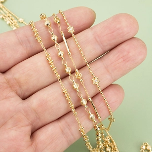 Golden flower and bead chain necklaces in various styles shown on a hand model