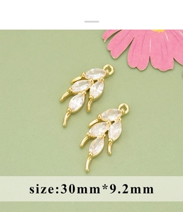 Detailed view of 30mm gold-plated wheat ear charms with cubic zirconia for DIY jewelry