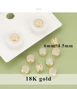 Macro detail of 6mm x 4.5mm 18K gold plated earring backs with translucent material