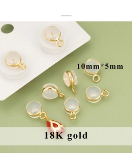 Detailed macro view of 10x5mm round 18K gold plated silicone earring backs with loops