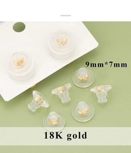 Macro shot of 18K gold plated silicone earring backings sized 9mm by 7mm for DIY jewelry