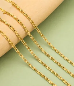 Macro detail of 1.9mm gold-plated stainless steel S-link chain wrapped on wood