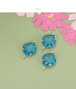 Detail of square sky blue glass charms with silver-tone connectors for DIY jewelry making