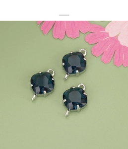 Detail of blue diamond-shaped glass charms with double loops for DIY jewelry making