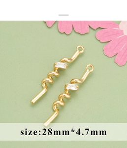 Detailed macro view of 18K gold plated spiral bow pendants with zircon for jewelry making