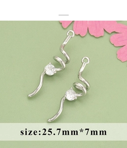 Close-up of spiral S-curve pendant with clear zircons and loop for DIY jewelry making