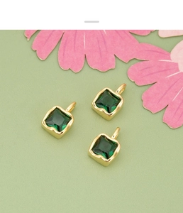 Macro view of three square green zircon pendants with gold frames for DIY jewelry