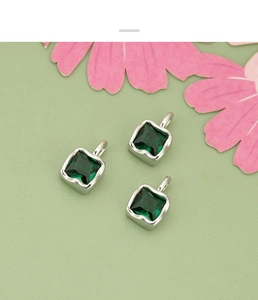 Macro shot of square green zircon pendants with silver plating for DIY jewelry making