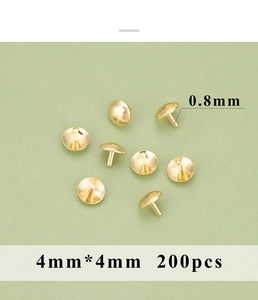 Macro detail of 4mm 18K gold-plated round metal rivets and pins on green background