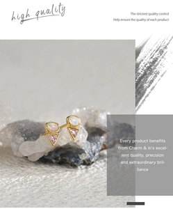 Macro detail of geometric triangle pink zircon and opal stud earrings in gold setting