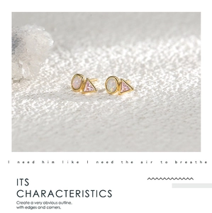 Close-up of geometric earrings featuring round opal and pink triangle zircon stones