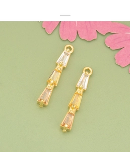 Detailed view of 18K gold plated geometric pendants with three-tier gradient zircons