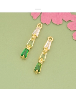 Detailed macro view of 18K gold plated pendant with gradient green zircon for DIY jewelry