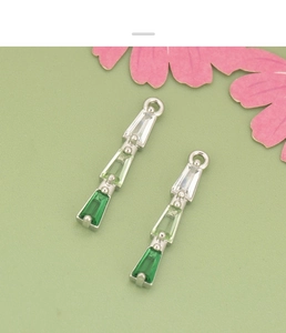 Macro view of gradient green zircon tiered pendants with integrated metal jump rings