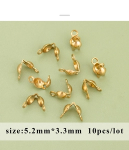 Macro detail of 5.2x3.3mm golden stainless steel fold-over cord end caps for DIY jewelry