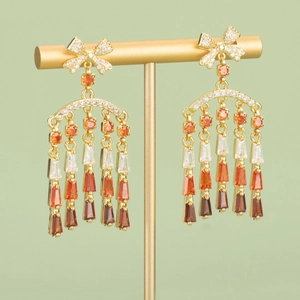Bow-knot fringe earrings with multi-color gradient zircon on a golden display stand