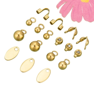 Golden stainless steel jewelry findings kit with clasps and beads on white background