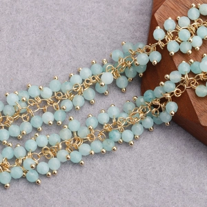 Detail of 18K gold-plated beaded chain featuring faceted light blue natural stones