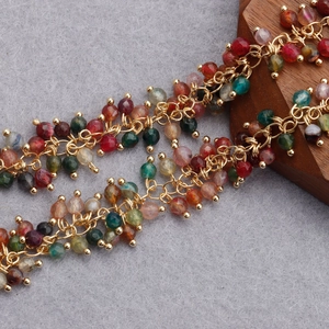 Macro detail of 18K gold plated beaded chain with colorful faceted quartz stones