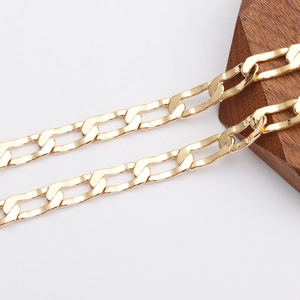 Detailed close-up of 18K gold plated Figaro chain with a polished mirror finish surface