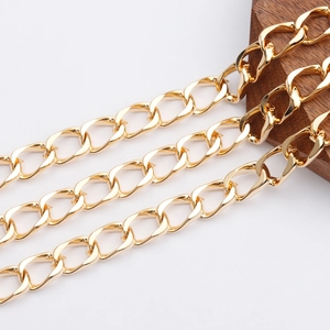Detail shot of heavy 18K gold plated O-shaped cross chain links on dark wood base