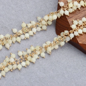 Close-up of 18K gold-plated beaded tassel chain with pale yellow translucent beads