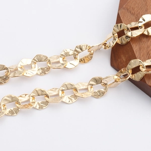 Close-up of 18K gold-plated O-chain featuring irregular hammered texture and flat links