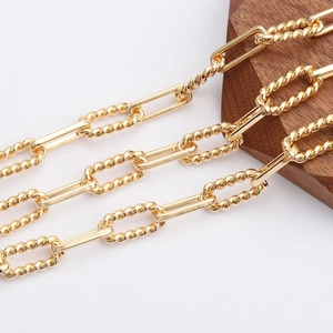 Macro shot of 18K gold plated textured oval and smooth rectangular link chains for DIY jewelry
