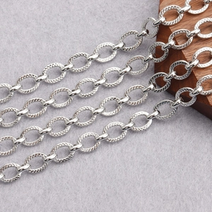 Detailed macro view of silver oval link chain with textured hammered finish for DIY jewelry