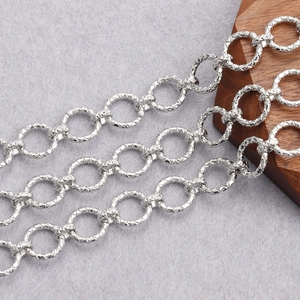 Close-up of textured 18K gold plated silver O-link chain with diamond-cut pattern detail
