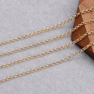 Macro view of 18K gold plated rolo chain links for DIY jewelry making on felt background