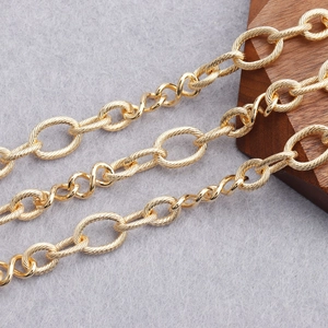Close-up of 18K gold plated textured oval and twisted links for DIY jewelry making