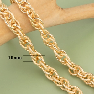 Detail showing 10mm wide gold textured heavy metal chain links on a wooden stand