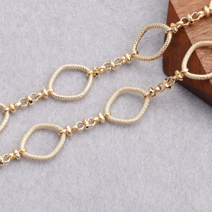 Macro shot of 18K gold plated O-shaped chain with textured diamond pattern links