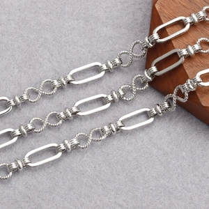 Macro shot of silver plated twisted infinity links and oval chain for DIY jewelry making