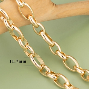 Detailed macro view of 11.7mm 18K gold plated oval link chain on a wooden base