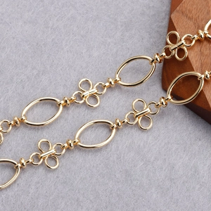 Macro detail of 18K gold plated O-shaped and clover link chain for DIY jewelry