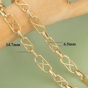 Macro detail of 18K gold plated chain links with 14.7mm infinity design on wood
