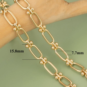 Macro view of 18K gold plated U-shaped link chain with dimensions 15.8mm and 7.7mm