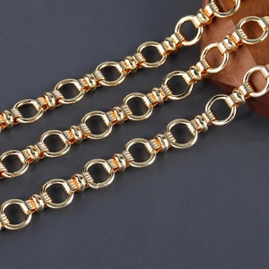 Macro detail of 18K gold plated chain with polished rings and textured ribbed connectors